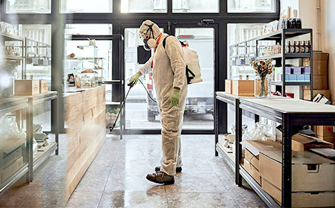 Man spraying down retail store with antibacterial solution. Commercial Cleaning